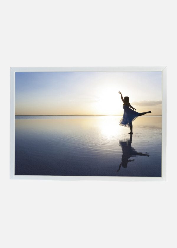 GIRL DANCING AT THE BEACH EDGE