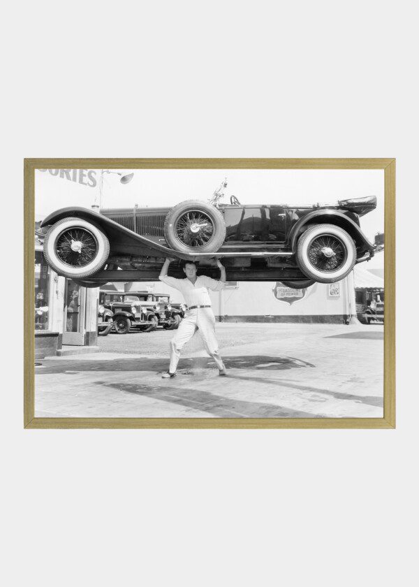 MAN LIFTING A CAR