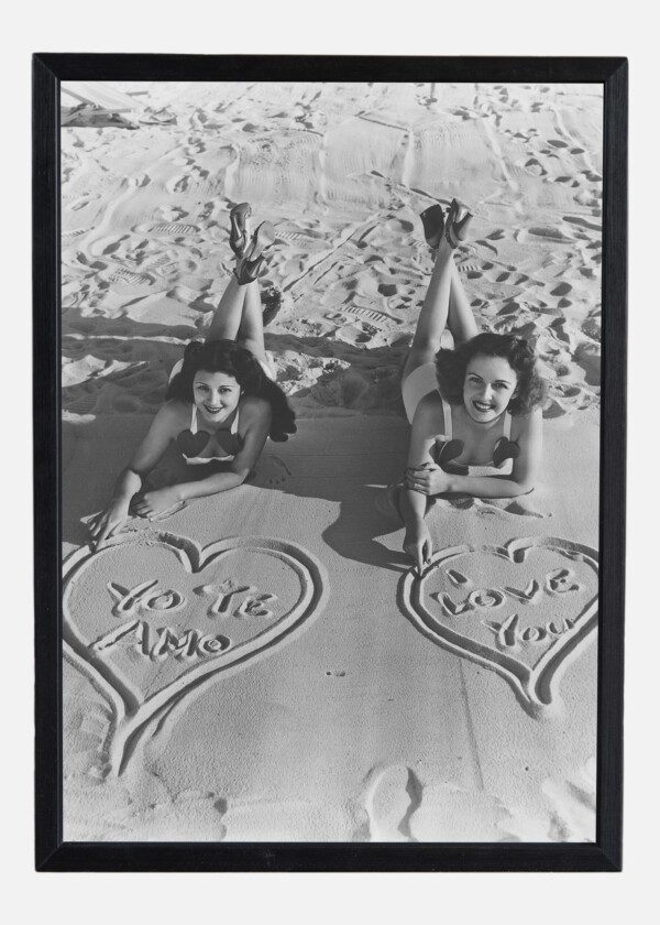 GIRLS DRAW HEARTS IN THE SAND