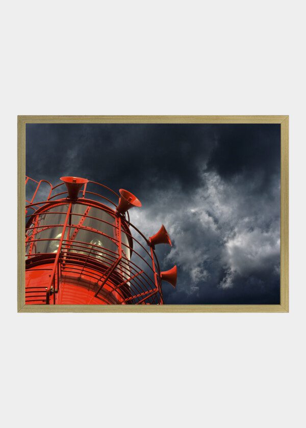 RED LIGHTHOUSE AGAINST BLUE SKY
