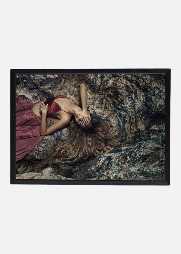 MODEL LIES ON STONES