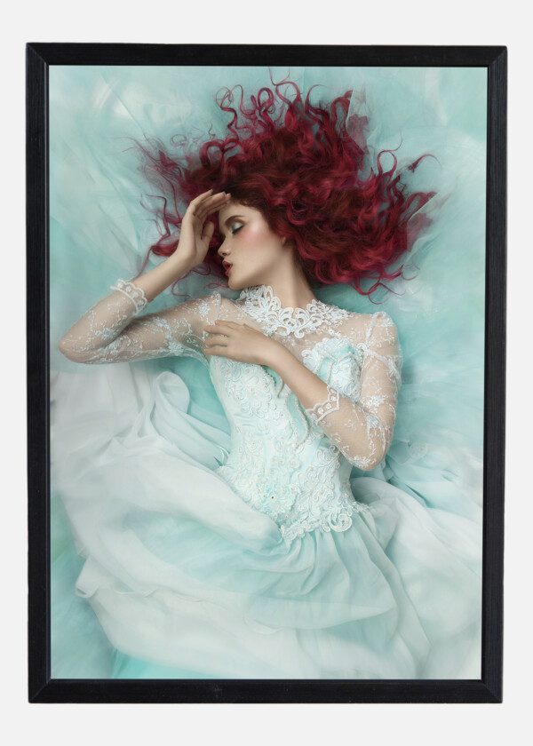 FASHION GIRL LYING IN A TURQUOISE DRESS