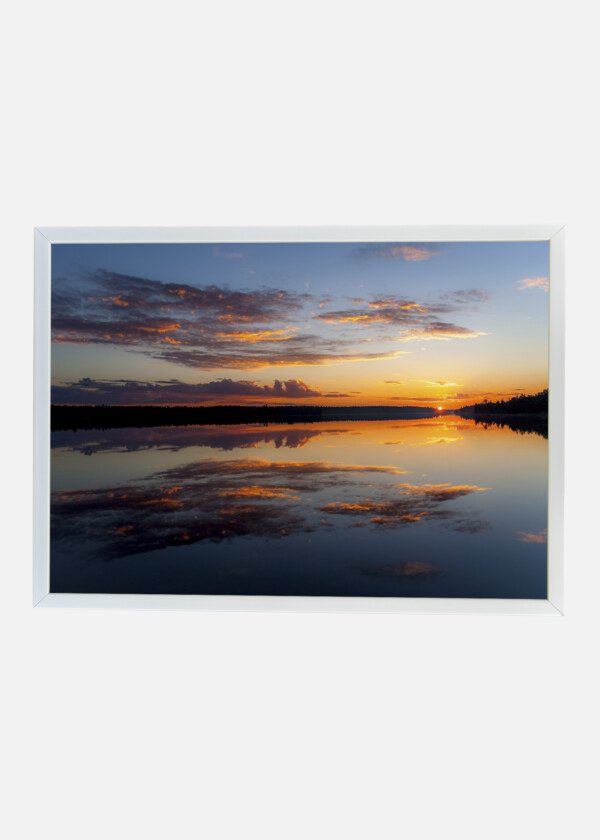 WATER REFLECTIONS AT MIDNIGHT SUN AT LAKE INARI IN FINLAND