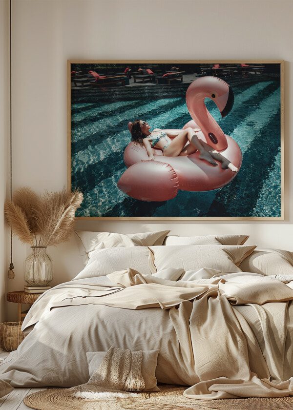 CUTE GIRL IN SUNGLASSES HAS FUN IN THE BLUE POOL WITH PINK INFLATABLE FLAMINGO-RING