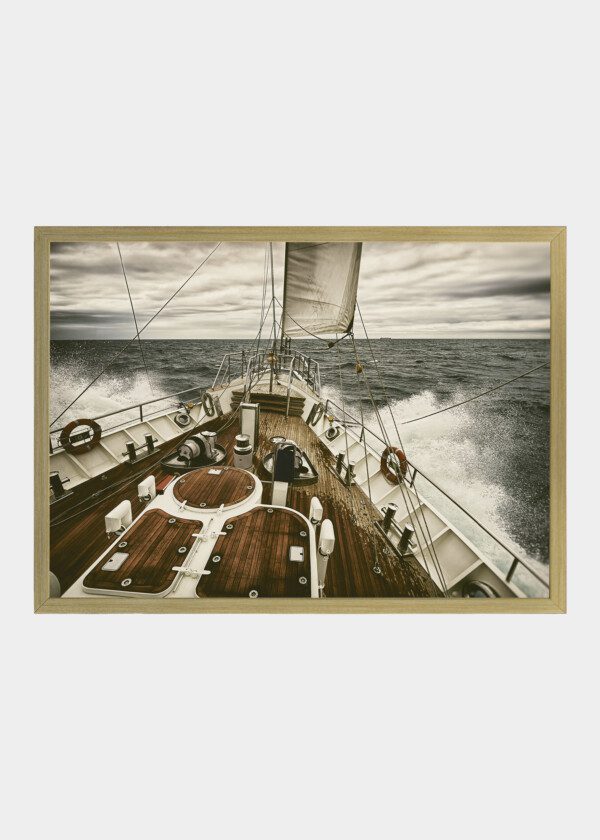 SAILING YACHT AT SUNSET DURING A STORM
