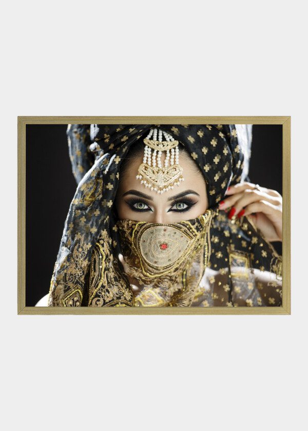 MODEL WEARING A TURBAN AND VEIL IN HEAVY EYE MAKEUP AND JEWELLERY