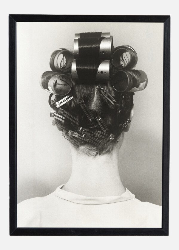 REAR VIEW OF WOMAN WITH CURLERS IN HER HAIR
