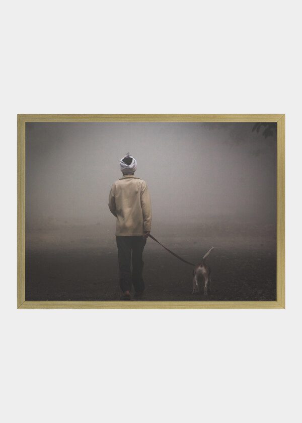 DOG-WALKING MAN, WEARING A TURBAN, ON A FOGGY MORNING