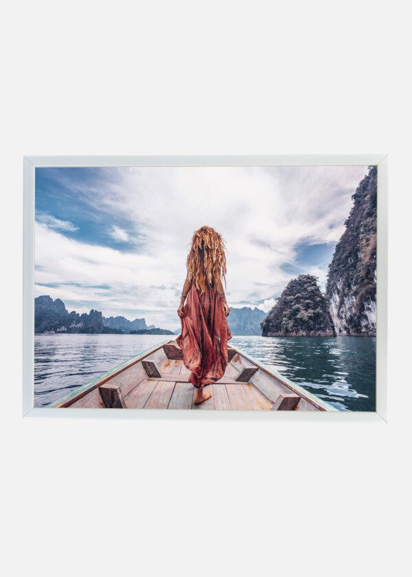 FASHIONABLE YOUNG MODEL IN BOHO STYLE DRESS ON BOAT AT THE LAKE
